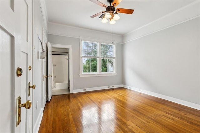 unfurnished bedroom with crown molding, wood-type flooring, and ceiling fan