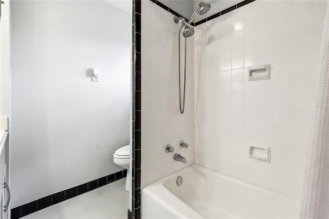 bathroom with toilet and shower / bath combo