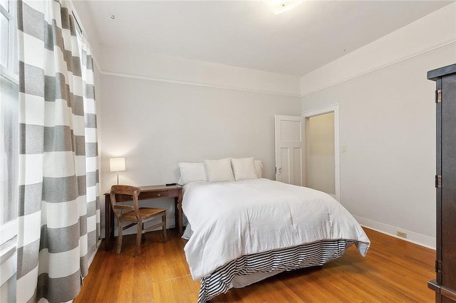 bedroom with hardwood / wood-style floors