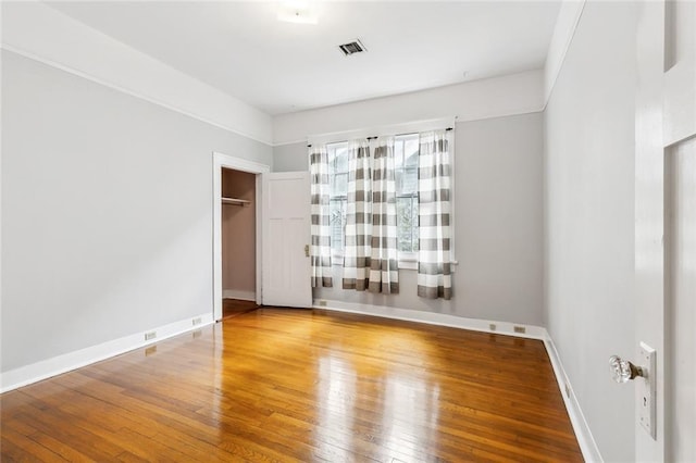 unfurnished bedroom featuring hardwood / wood-style floors and a closet