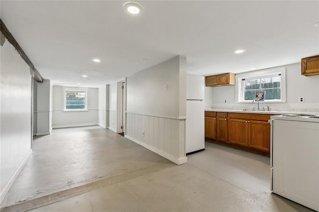 kitchen with range, sink, and white fridge