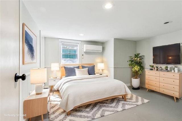 bedroom featuring a wall mounted air conditioner and concrete floors