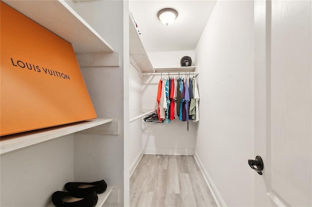 spacious closet featuring hardwood / wood-style flooring