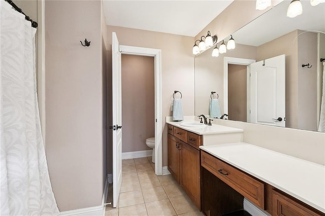 bathroom with vanity, tile patterned floors, and toilet