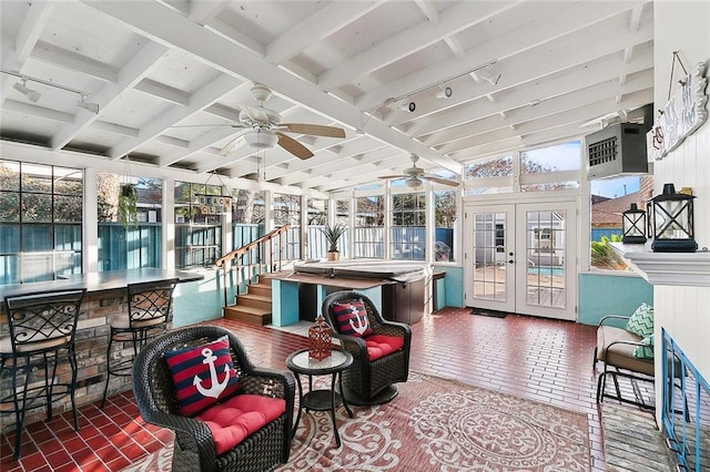 sunroom / solarium featuring french doors, an AC wall unit, beam ceiling, and rail lighting