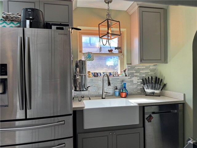 kitchen featuring sink, stainless steel fridge, gray cabinets, dishwasher, and decorative backsplash