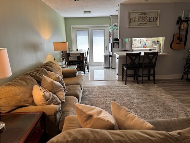 living room with sink and light hardwood / wood-style floors