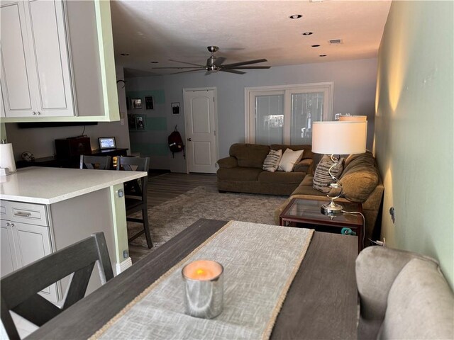 living room with ceiling fan and wood-type flooring