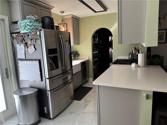 kitchen with stainless steel refrigerator with ice dispenser, pendant lighting, dishwasher, and gray cabinetry