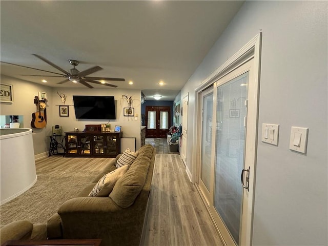 living room with hardwood / wood-style flooring and ceiling fan