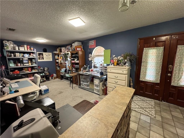 tiled office space featuring a textured ceiling and french doors