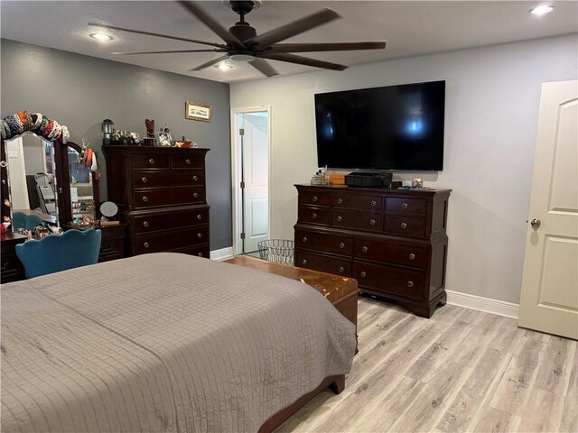 bedroom with ceiling fan and light wood-type flooring