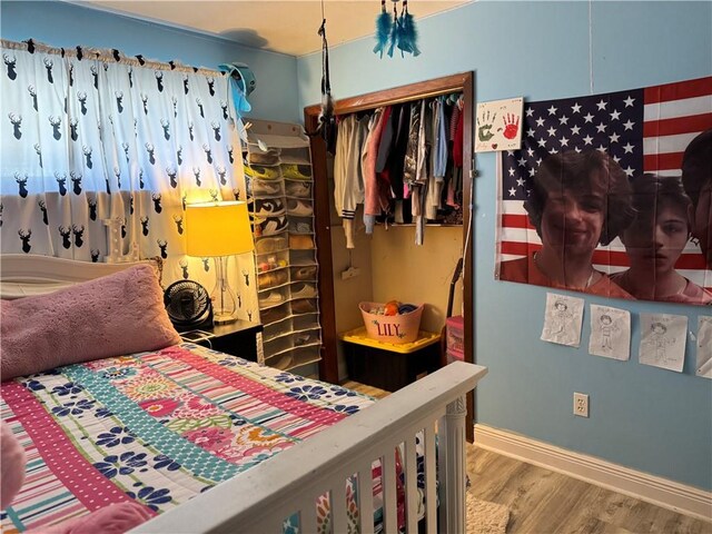 bedroom with ceiling fan and hardwood / wood-style floors