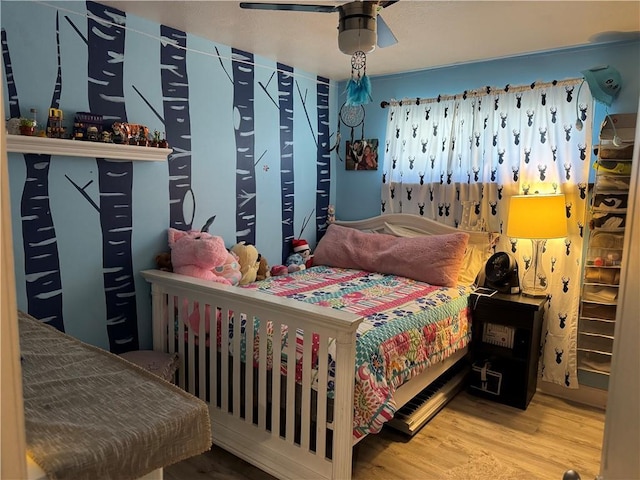 bedroom with hardwood / wood-style flooring and ceiling fan