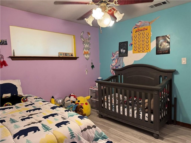 bedroom with ceiling fan and light wood-type flooring