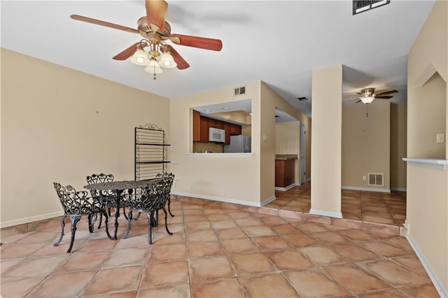 dining space with light tile patterned floors and ceiling fan