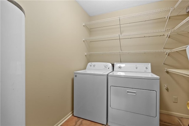 clothes washing area featuring washer and dryer