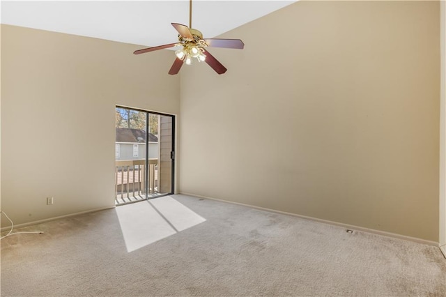 spare room featuring ceiling fan, light colored carpet, and a towering ceiling