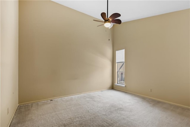 carpeted spare room featuring a high ceiling and ceiling fan