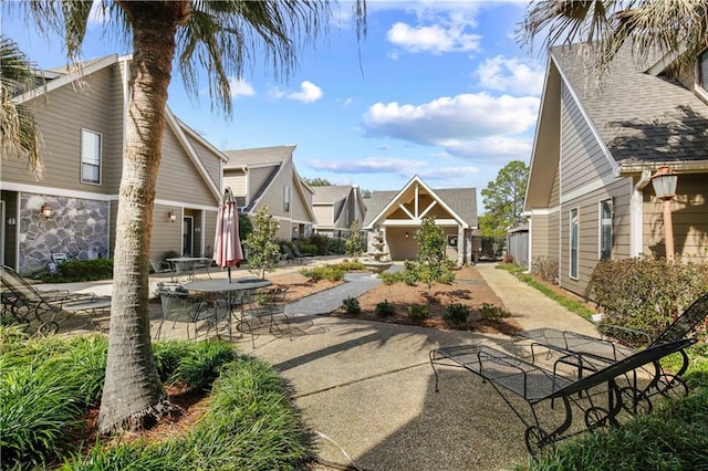 view of property's community with a patio area