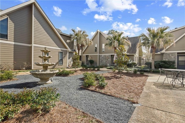 view of property's community with a patio area