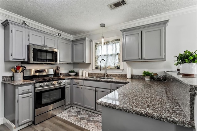 kitchen with crown molding, appliances with stainless steel finishes, sink, and gray cabinetry