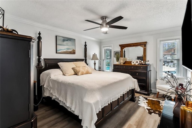 bedroom with crown molding, ceiling fan, dark hardwood / wood-style flooring, and a textured ceiling