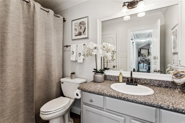 bathroom featuring ornamental molding, vanity, and toilet