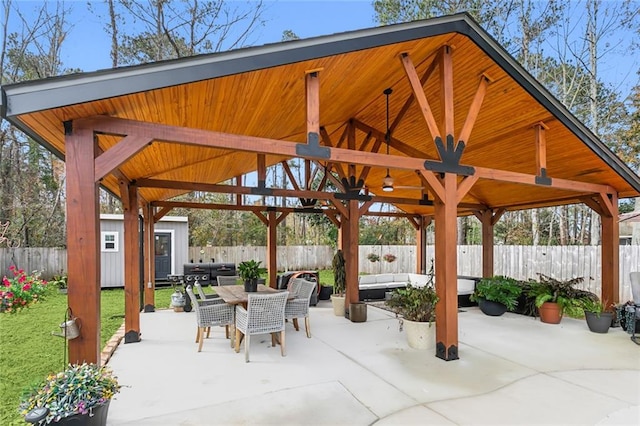 view of patio / terrace with a shed, a grill, a gazebo, and outdoor lounge area