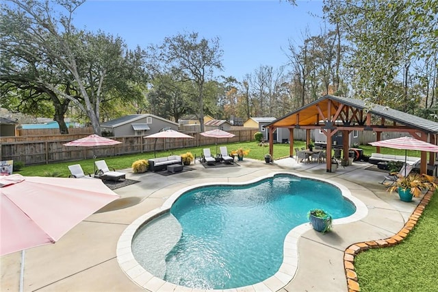 view of pool with a gazebo, outdoor lounge area, a patio area, and a lawn