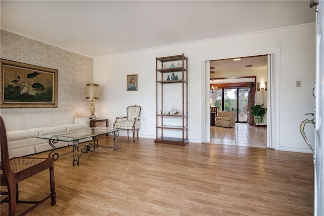 living room with crown molding and light hardwood / wood-style floors