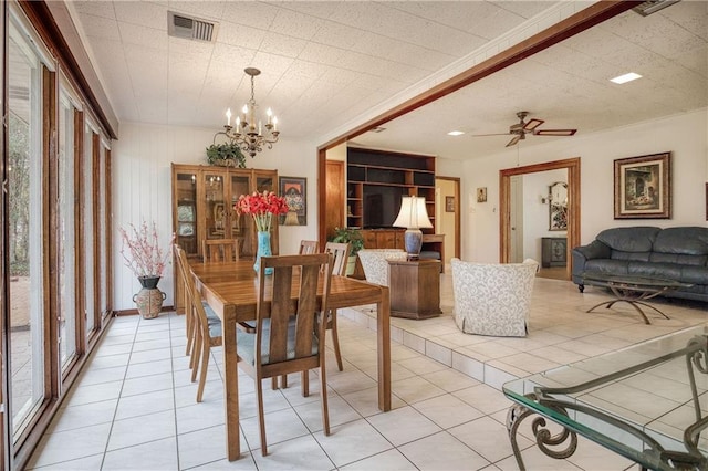 tiled dining space featuring ceiling fan with notable chandelier