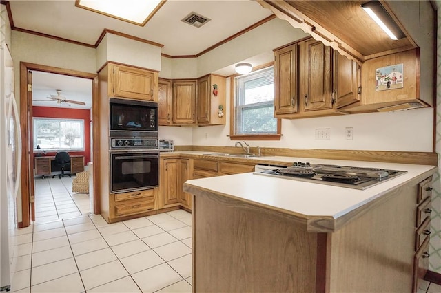 kitchen featuring light tile patterned flooring, sink, ornamental molding, kitchen peninsula, and black appliances