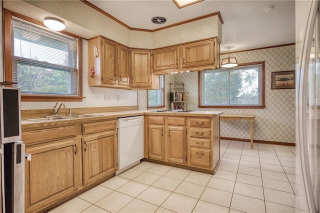 kitchen with light tile patterned flooring, sink, ornamental molding, kitchen peninsula, and white appliances