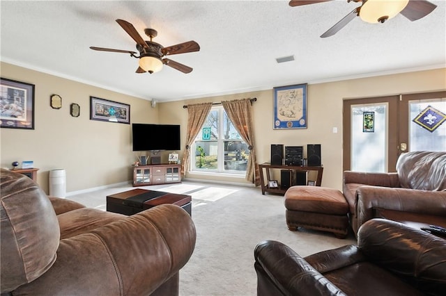 living room with ornamental molding, ceiling fan, light carpet, a textured ceiling, and french doors