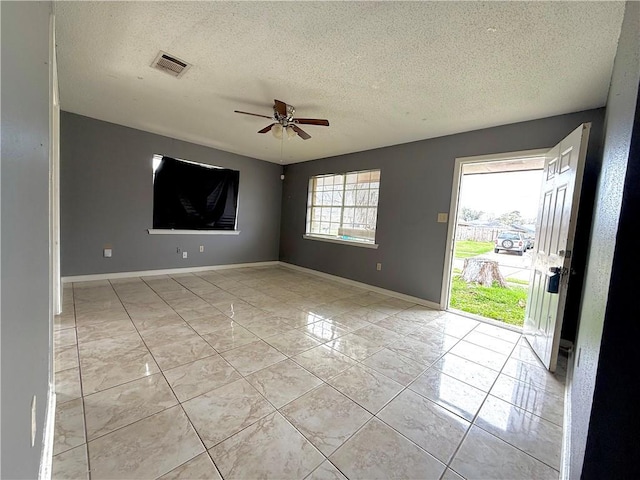 interior space with a textured ceiling and ceiling fan