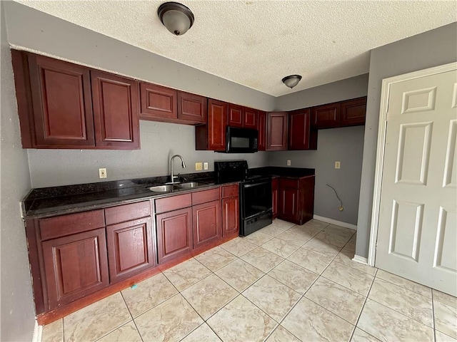 kitchen with light tile patterned floors, sink, a textured ceiling, and black appliances