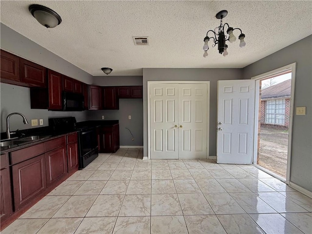 kitchen with an inviting chandelier, sink, a textured ceiling, decorative light fixtures, and black appliances