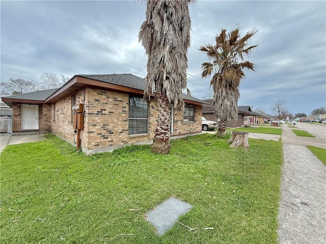 view of property exterior featuring a garage and a lawn