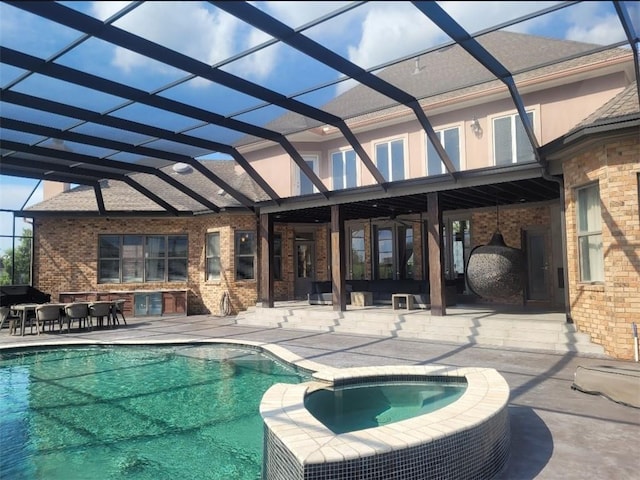 view of swimming pool with an in ground hot tub, a lanai, and a patio area