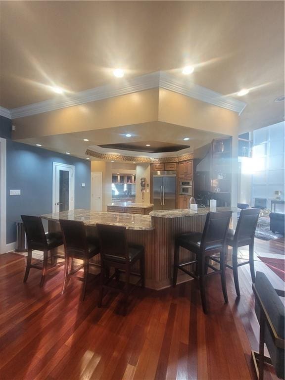 bar with dark hardwood / wood-style flooring, crown molding, and appliances with stainless steel finishes