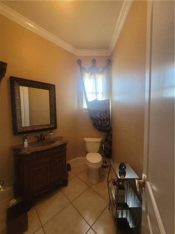 bathroom with crown molding, vanity, tile patterned floors, and toilet