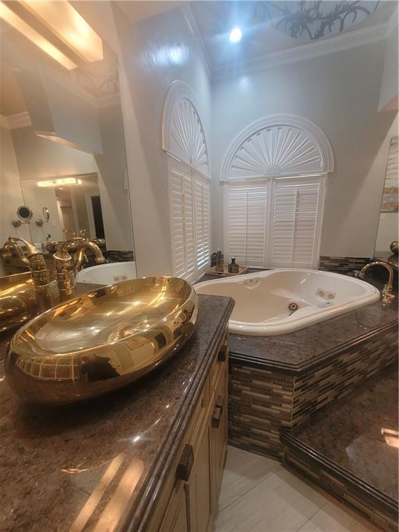 bathroom with a towering ceiling, vanity, a relaxing tiled tub, ornamental molding, and tile patterned floors