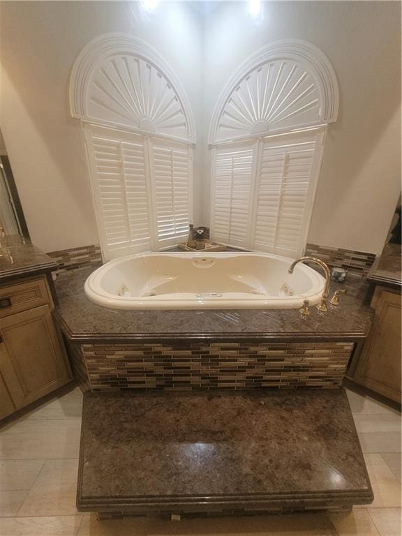 bathroom with a relaxing tiled tub