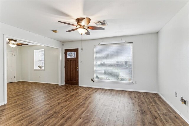 entryway with dark wood-type flooring and ceiling fan