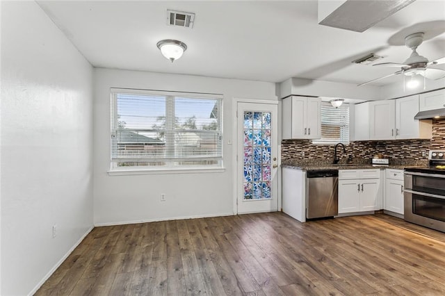 kitchen with sink, stainless steel appliances, dark hardwood / wood-style floors, tasteful backsplash, and white cabinets