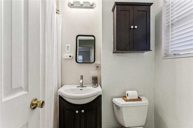 bathroom featuring toilet and vanity