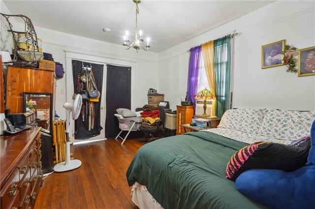 171315 8th St, New Orleans, LA 70115 - bedroom featuring a notable chandelier and wood finished floors