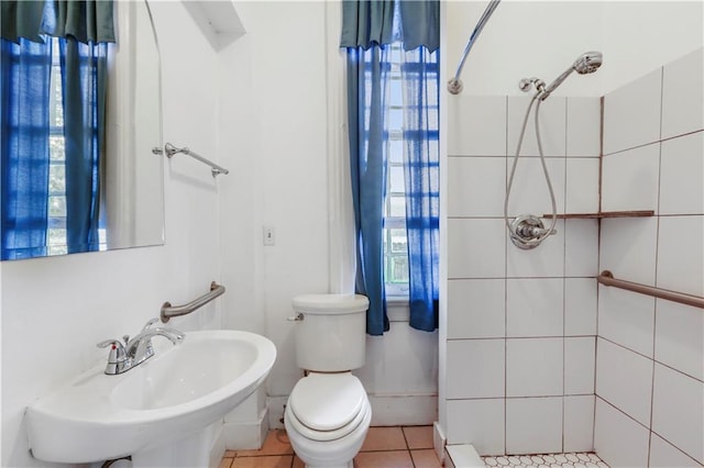 bathroom with tile patterned flooring, sink, toilet, and walk in shower