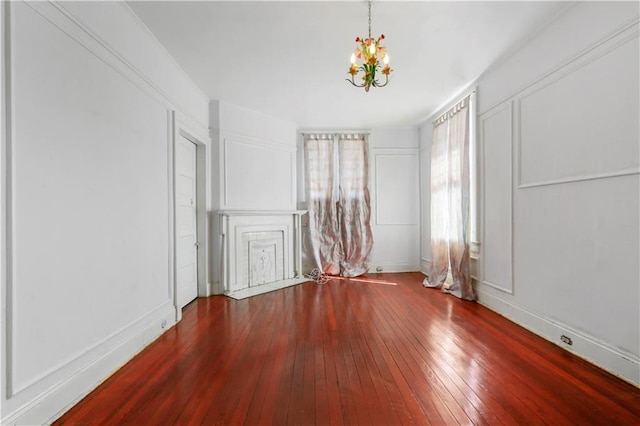 unfurnished room featuring hardwood / wood-style floors and a notable chandelier